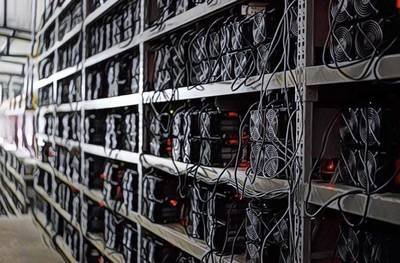 Aerial view of a solar-powered mining farm, emphasizing the vast array of solar panels.